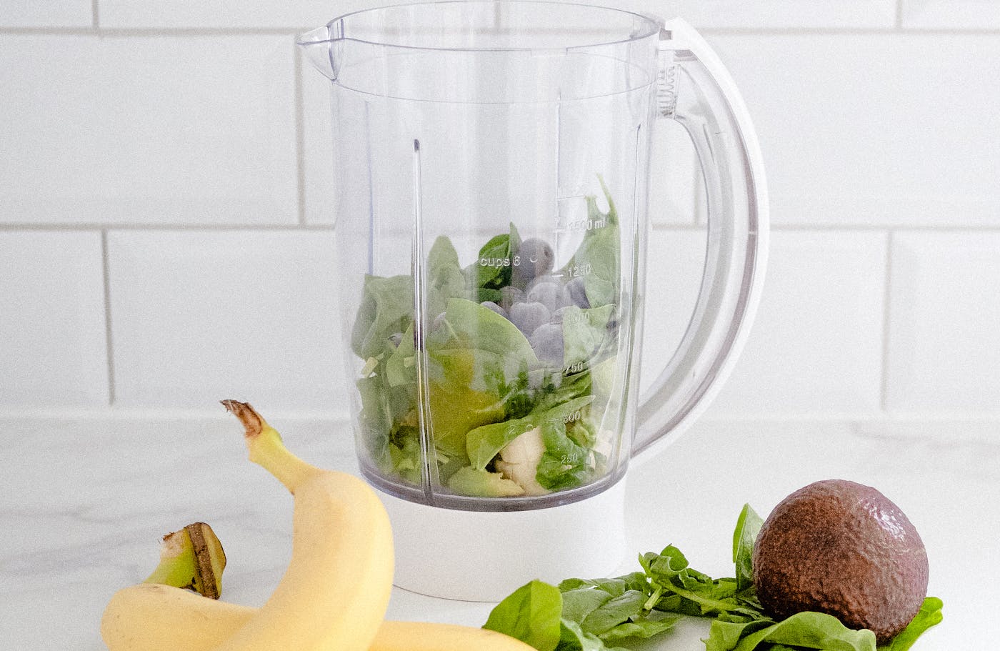 A clean countertop with a plant-based protein shake and a supplement bottle arranged with white space — symbolizing simplicity and clarity